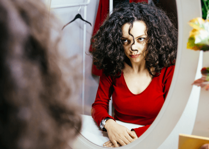 woman looking into the mirror